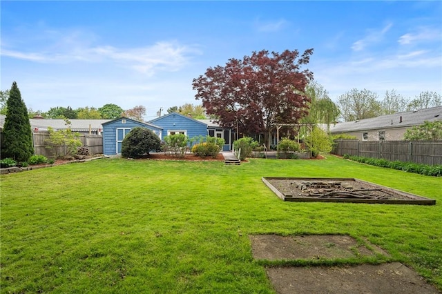 view of yard with a shed, an outbuilding, and a garden