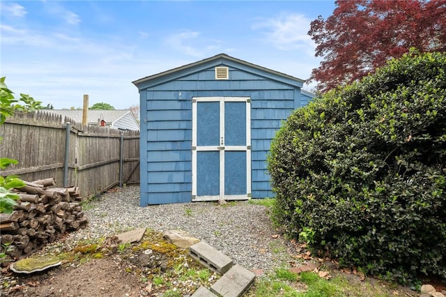 view of shed with fence