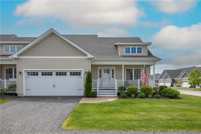 9 Thelma Ln, Middletown, RI 02842 - view of front of home featuring covered porch, a front lawn, driveway, and an attached garage