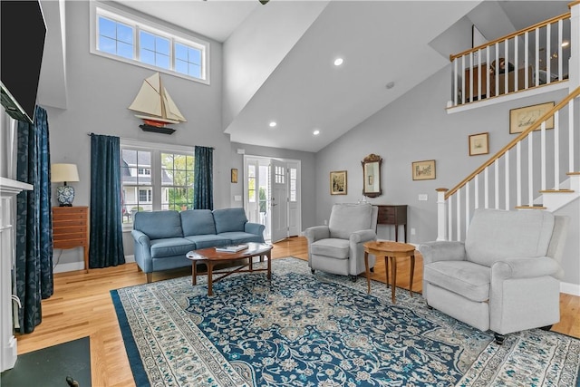 9 Thelma Ln, Middletown, RI 02842 - living room with a high ceiling, wood finished floors, stairway, baseboards, and recessed lighting
