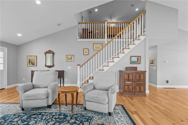9 Thelma Ln, Middletown, RI 02842 - living area featuring light wood-style flooring, stairs, baseboards, high vaulted ceiling, and recessed lighting