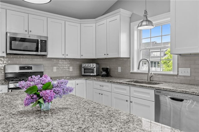 9 Thelma Ln, Middletown, RI 02842 - kitchen with appliances with stainless steel finishes, a sink, white cabinetry, light stone countertops, and lofted ceiling