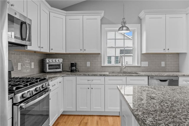 9 Thelma Ln, Middletown, RI 02842 - kitchen with stainless steel appliances, a sink, and white cabinetry