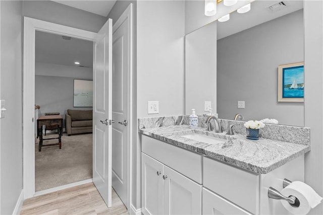 9 Thelma Ln, Middletown, RI 02842 - bathroom with wood finished floors, vanity, and recessed lighting