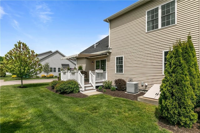 9 Thelma Ln, Middletown, RI 02842 - rear view of property with central air condition unit, a deck, and a lawn
