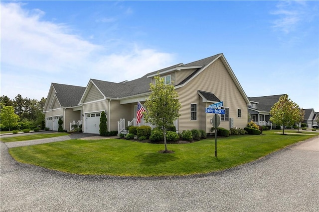 9 Thelma Ln, Middletown, RI 02842 - traditional home featuring an attached garage, asphalt driveway, and a front lawn
