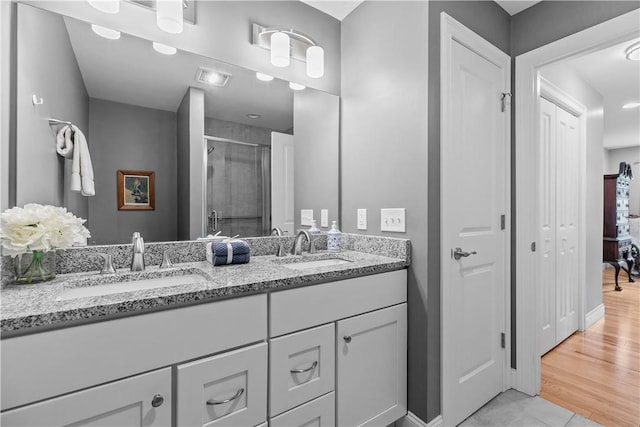 9 Thelma Ln, Middletown, RI 02842 - bathroom with a stall shower, double vanity, baseboards, and tile patterned flooring