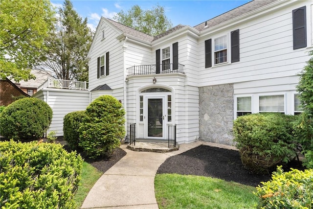 view of front of property with a balcony and stone siding