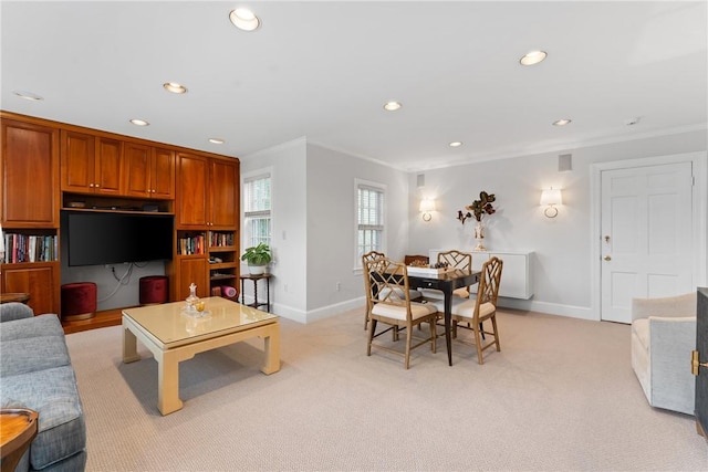 living room featuring ornamental molding, baseboards, recessed lighting, and light colored carpet