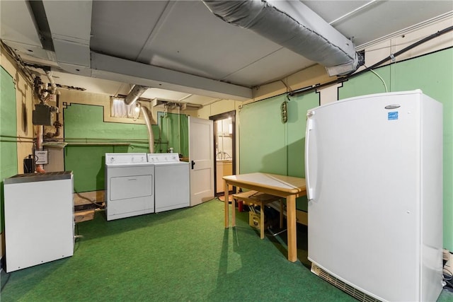 below grade area featuring freestanding refrigerator, washer and clothes dryer, and carpet flooring