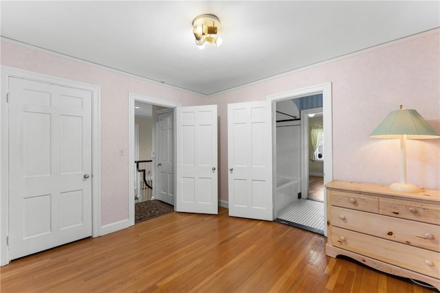 bedroom with light wood-type flooring and baseboards