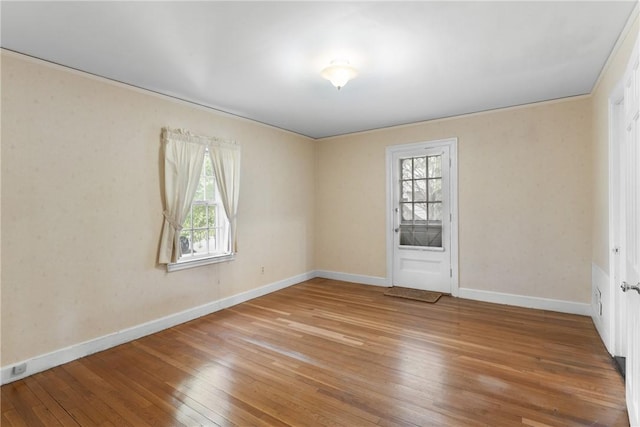 spare room with hardwood / wood-style flooring and baseboards
