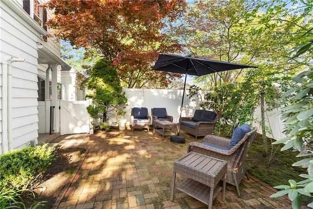 view of patio / terrace featuring a fenced backyard, an outdoor hangout area, and a gate