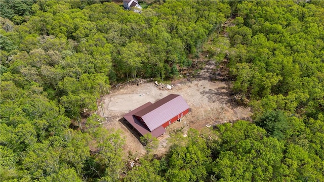 view from above of property with a heavily wooded area