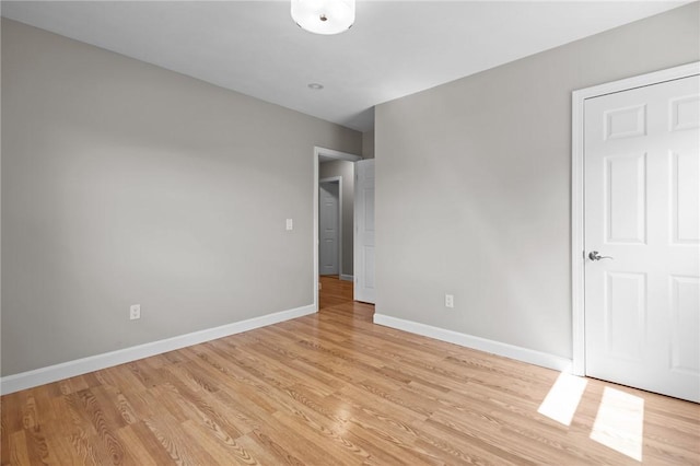 unfurnished bedroom featuring light wood-style floors and baseboards