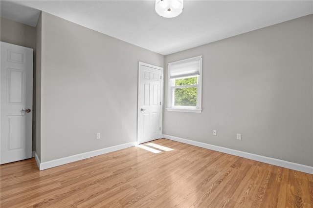 unfurnished bedroom with baseboards and light wood finished floors