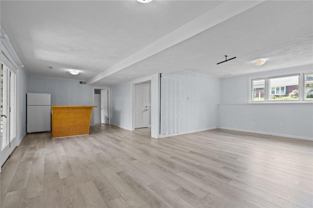 unfurnished living room featuring light wood-style floors and baseboards