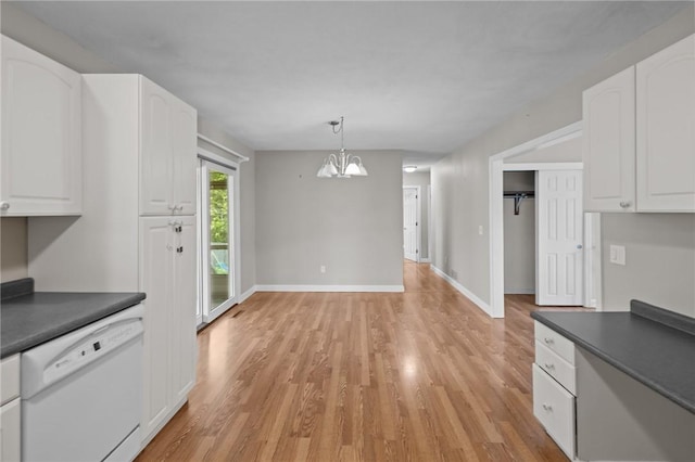kitchen with white dishwasher, dark countertops, white cabinets, and light wood finished floors