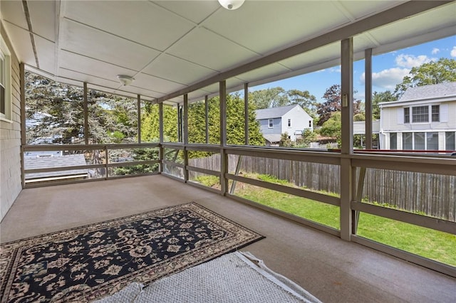 unfurnished sunroom with a residential view