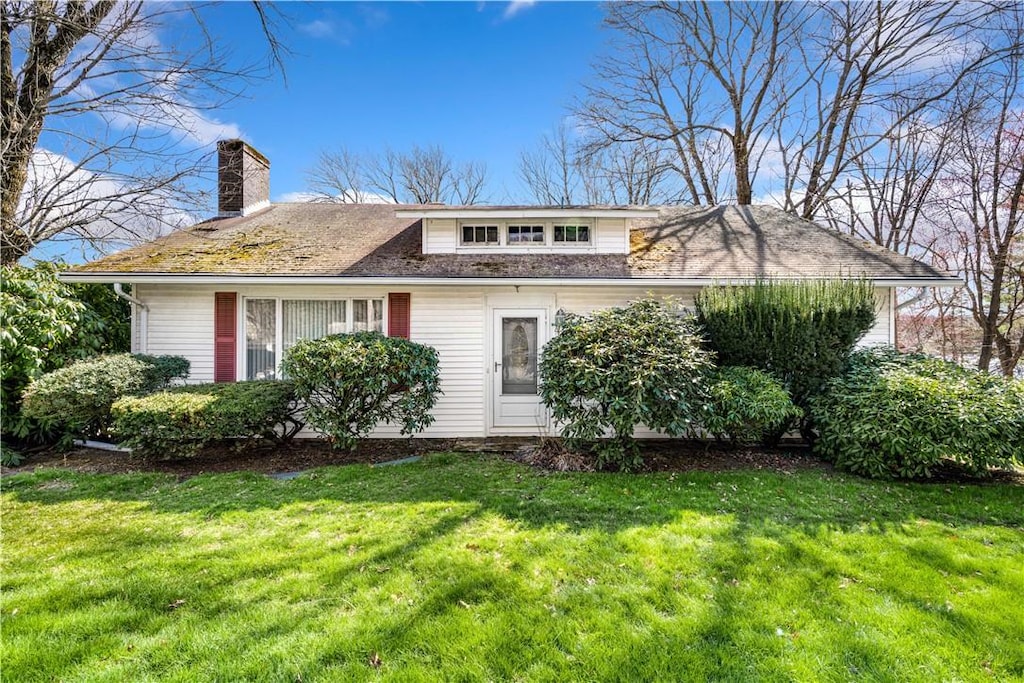 2444 Hartford Ave, Johnston, RI 02919 - view of front of property featuring a front lawn and a chimney