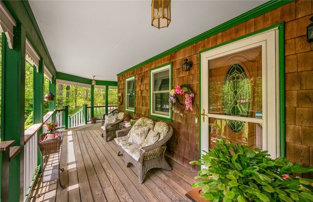 wooden terrace featuring covered porch