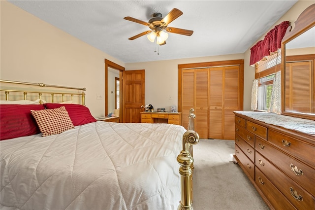 bedroom with a closet, light carpet, and a ceiling fan