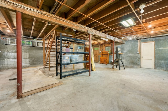 unfinished basement featuring stairway