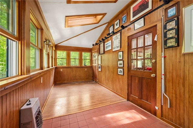 unfurnished sunroom with lofted ceiling and heating unit
