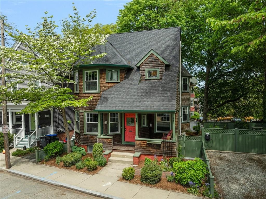 3 Hidden St, Providence, RI 02906 - view of front of property with a porch, a shingled roof, and fence