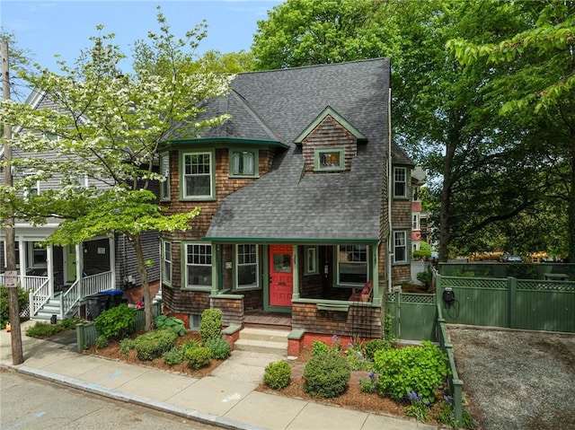 3 Hidden St, Providence, RI 02906 - view of front of property with a porch, a shingled roof, and fence