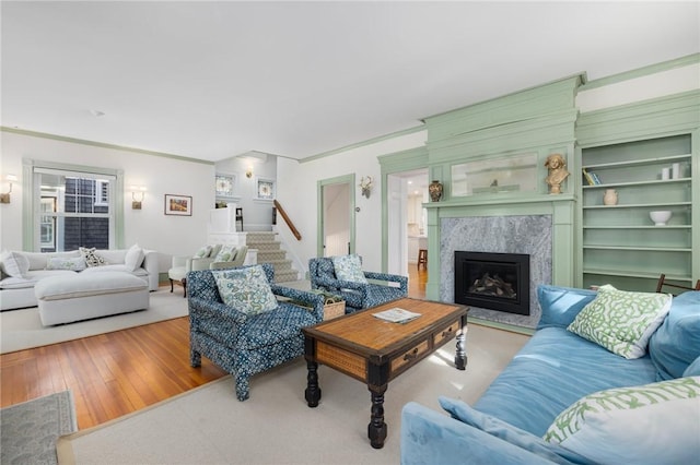 3 Hidden St, Providence, RI 02906 - living area featuring a premium fireplace, stairs, and wood finished floors