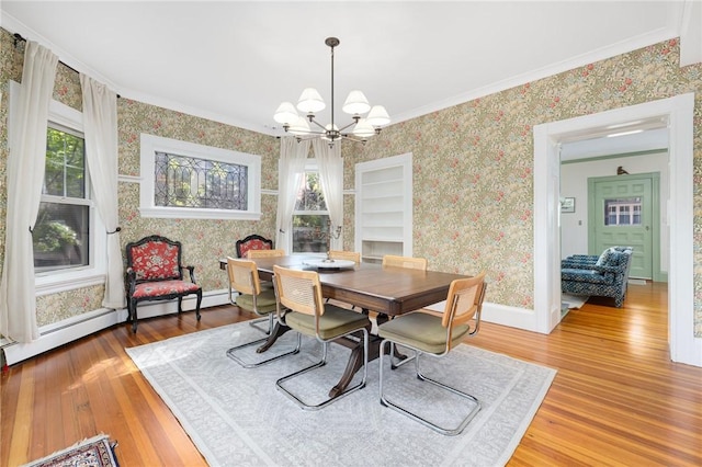 3 Hidden St, Providence, RI 02906 - dining area featuring wallpapered walls, a chandelier, light wood-style floors, crown molding, and plenty of natural light