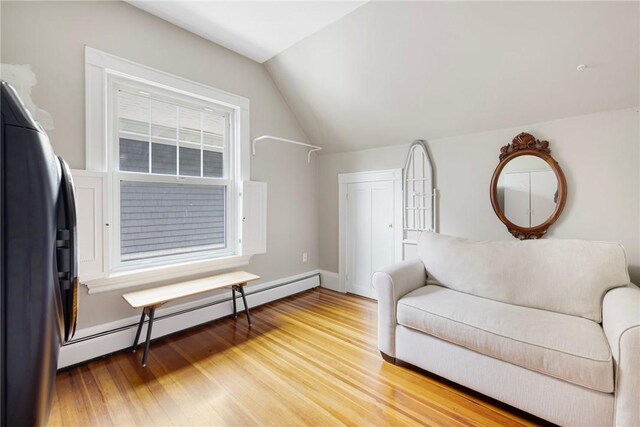 3 Hidden St, Providence, RI 02906 - living area with a baseboard heating unit, light wood-style flooring, vaulted ceiling, and baseboards