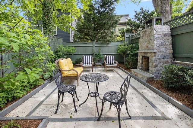 3 Hidden St, Providence, RI 02906 - view of patio featuring an outdoor stone fireplace and a fenced backyard