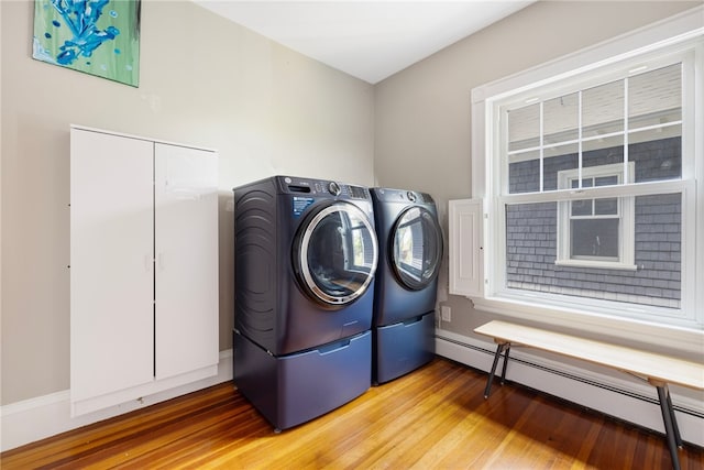 3 Hidden St, Providence, RI 02906 - laundry room featuring a baseboard radiator, washing machine and clothes dryer, and wood finished floors