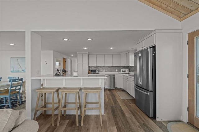 419 Atlantic Ave, Westerly, RI 02891 - kitchen with stainless steel appliances, a peninsula, a kitchen bar, white cabinetry, and recessed lighting