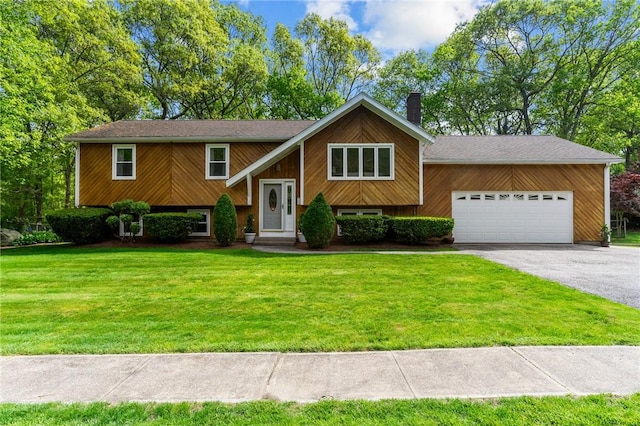 23 Watercress Ct, Coventry, RI 02816 - raised ranch featuring an attached garage, a chimney, a front yard, and driveway