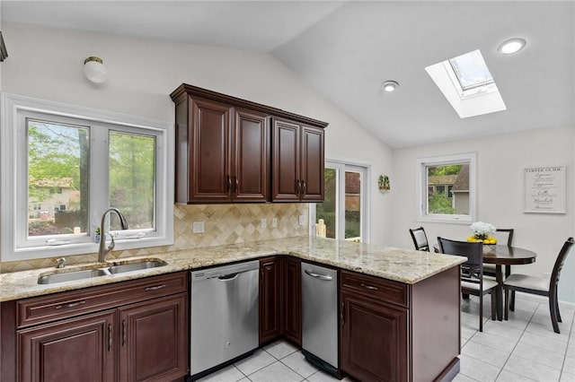 23 Watercress Ct, Coventry, RI 02816 - kitchen with stainless steel dishwasher, a sink, a skylight, lofted ceiling, and a peninsula