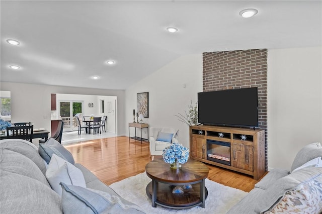 23 Watercress Ct, Coventry, RI 02816 - living area featuring wood finished floors, vaulted ceiling, a brick fireplace, and recessed lighting