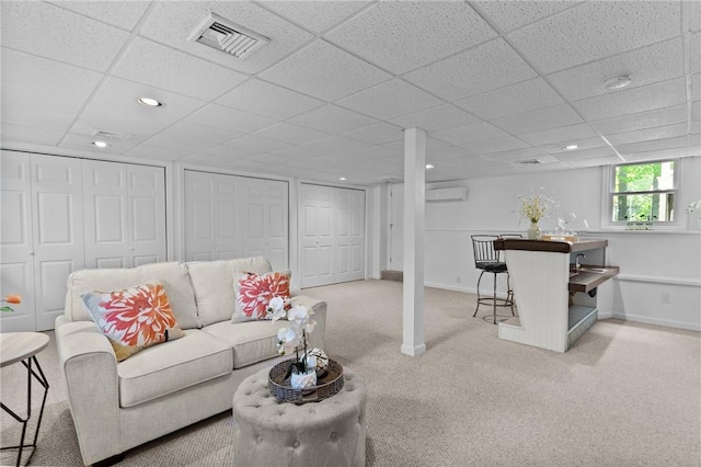 23 Watercress Ct, Coventry, RI 02816 - carpeted living room with an AC wall unit, a drop ceiling, baseboards, and recessed lighting