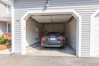 view of vehicle parking with a garage