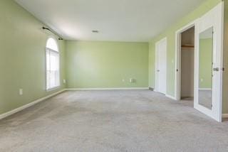 unfurnished room with carpet floors and baseboards