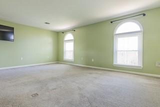 carpeted spare room with baseboards