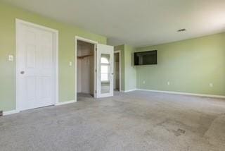 unfurnished bedroom featuring carpet and baseboards