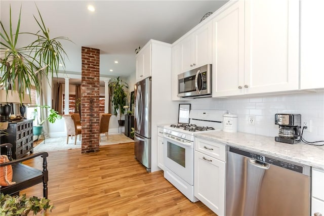 94 Bentley St, East Providence, RI 02914 - kitchen featuring appliances with stainless steel finishes, backsplash, white cabinets, and recessed lighting