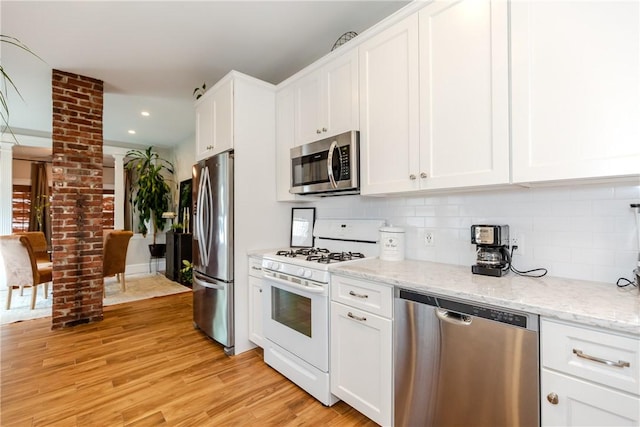 94 Bentley St, East Providence, RI 02914 - kitchen featuring stainless steel appliances, backsplash, white cabinetry, and recessed lighting