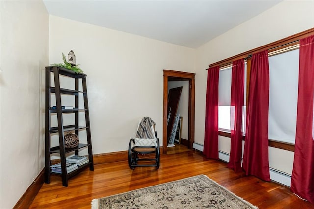 94 Bentley St, East Providence, RI 02914 - foyer entrance featuring wood finished floors, baseboard heating, and baseboards