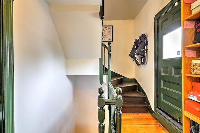 stairs featuring hardwood / wood-style floors