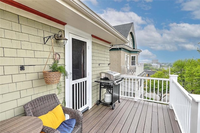 wooden deck featuring area for grilling