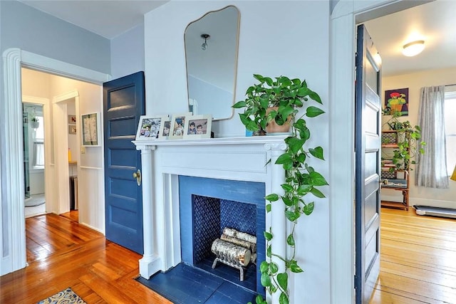 living room featuring hardwood / wood-style floors and a fireplace with flush hearth